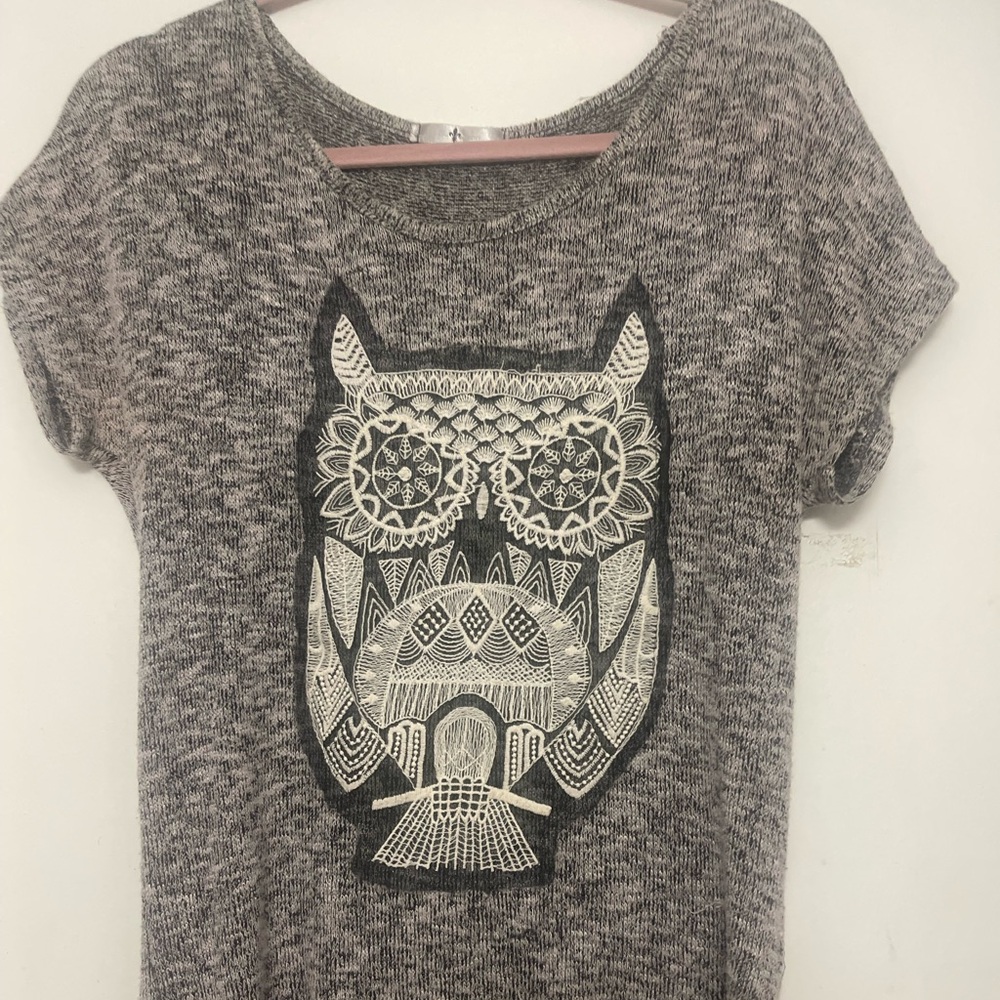 Women’s top with owl on front .